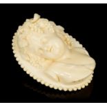 Fine quality 19th century carved ivory oval brooch depicting a putto / cherub,