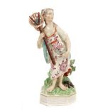 18th century Derby figure of a fishergirl holding a net and with fish in the folds of her dress and