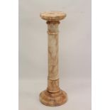 Carved pink variagated marble column with circular socle on cylindrical column and stepped base,