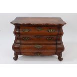 19th century Dutch apprentice-piece miniature bombe commode of shaped outline,