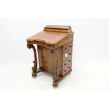 Victorian walnut davenport with surmounting galleried stationery compartment and leather inset