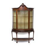 1920s mahogany display cabinet in the manner of Gillows, of bowed form,