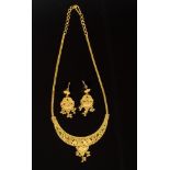 Indian yellow metal and enamel necklace and matching earrings with filigree decoration and tassel