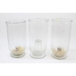 Three 19th century glass storm lanterns with large funnel bowls with rolled edges,