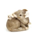 Good Japanese Meiji period carved ivory netsuke in the form of a rat, nibbling a fruit,