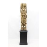 19th century Indian carved wooden sepoy figure carved holding a spear, seated on a lion,