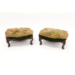 Pair of Victorian walnut footstools, each of serpentine outline,