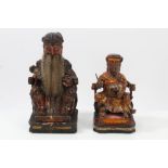 Two late 19th century Chinese carved wooden and polychrome figures of a scribe and an emperor on