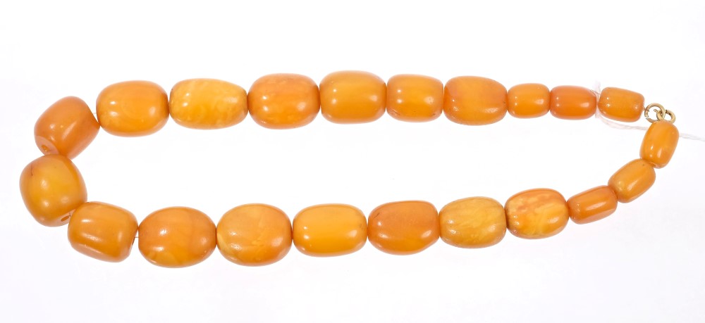 Old amber necklace with a string of twenty-one graduated oval butterscotch amber beads,