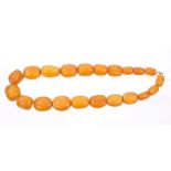 Old amber necklace with a string of twenty-one graduated oval butterscotch amber beads,