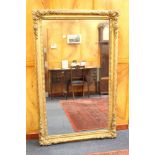 Victorian gilt gesso wall mirror with rectangular bevelled plate in moulded gesso frame,