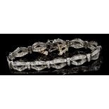 Diamond bracelet with articulated panels of baguette cut diamonds in a ribbon design,
