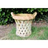 Antique terracotta garden urn of pierced waisted form, with basketwork finish,