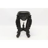 Antique Burmese carved hardwood urn stand of circular form,