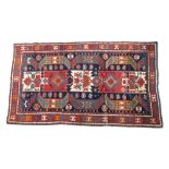 Old Kelim rug with geometric segmented field on cream, red and blue ground,