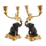 Regency-style pair of patinated bronze and ormolu twin-branch candlesticks,