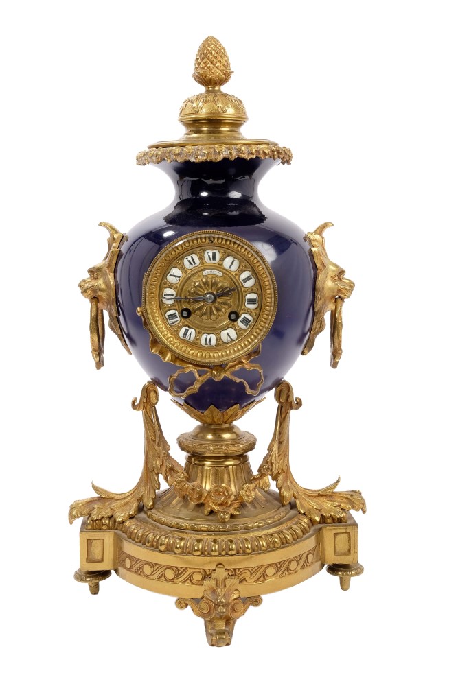 Late 19th century French Louis XV revival mantel clock with blue porcelain urn and ornate ormolu