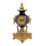 Late 19th century French Louis XV revival mantel clock with blue porcelain urn and ornate ormolu
