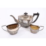 George V silver three piece tea set - comprising teapot of half-fluted form,
