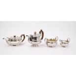 George IV silver three piece tea set of half-fluted form - comprising teapot with engraved crest