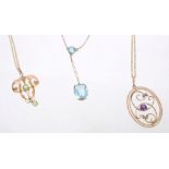 Three Edwardian gold pendant necklaces - to include a blue topaz two-stone pendant necklace,