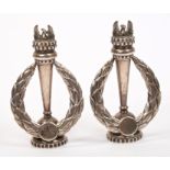 Pair silver standing emblems in the form of a phoenix rising from a torch,