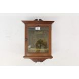 19th century mahogany wall hanging display case with fret-carved cresting enclosed by glazed door,