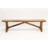 Antique pine bench raised on V-end supports and stretchers,