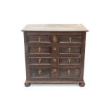 Late 17th century oak geometric chest having four geometric moulded drawers, raised on bun feet,