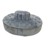 Victorian-style blue button-upholstered conversation seat of oval form,