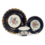 18th century Worcester polychrome cup and saucer with painted floral sprays on gilt and 'wet' blue