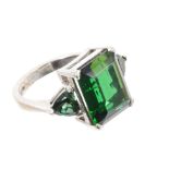 18ct white gold and green tourmaline three-stone ring with a central rectangular step cut stone