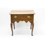 18th century elm lowboy with frieze drawer and shaped apron, on cabriole legs and pad feet,