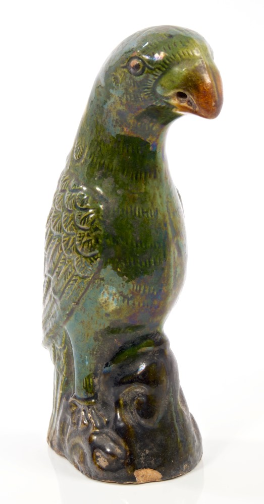 19th century Chinese green glazed pottery parrot with moulded and incised feathers, on rococo base,