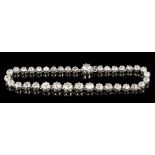 Diamond bracelet with a continuous line of thirty-five graduated old cut diamonds with a further