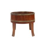 19th century mahogany and brass bound wine cooler of oval coopered form,