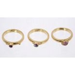 Three gem set 'stacking' rings, with purple and pink stones, tests as approximately 18ct gold.