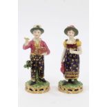 Pair early 19th century Derby figures of a boy and girl holding basket of chicks and floral spray