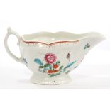 18th century Worcester moulded sauce boat, circa 1770, with polychrome painted floral decoration,