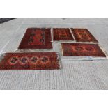 Pakistan rug with segmented field on brick-red ground in geometric borders, 200cm x 103cm,