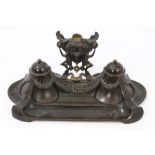 Late 19th century Continental bronze and patinated ink stand with twin-lidded ornament wells raised