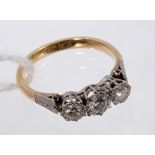 Diamond three-stone ring with three brilliant cut diamonds in illusion platinum setting,