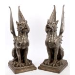 Pair of substantial nickel plated cast iron dragon ornaments, each of seated form, on square plinth,