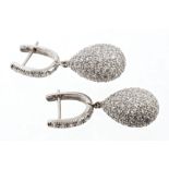 Pair diamond pendant earrings, each with a pear-shape drop,