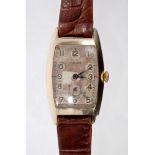 Gentlemen's 1930s Longines wristwatch in gold-filled curved tonneau-shaped case with silvered dial,
