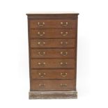 Edwardian mahogany and tulipwood crossbanded narrow chest, having bank of seven drawers,