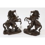 Pair of patinated bronze Marley horse groups, stamped 30 to base,