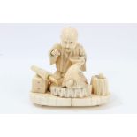 Japanese Meiji period carved ivory okimono modelled as an armourer, seated,