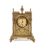Early Victorian mantel clock in ornate gilt brass Gothic architectural case with brass dial,