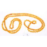 Amber necklace with a long string of spherical amber beads, approximately 7mm diameter,